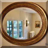 D12. Gold trimmed oval mirror. 37”h x 50”w 
